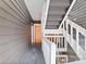 Stairwell leading to a unit featuring painted wood railing and a solid front door at 434 W 8Th St, Charlotte, NC 28202