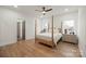 This bedroom features a modern four-poster bed, wood floors, and an ensuite bathroom for a comfortable retreat at 4890 Rio De Luna None, Hickory, NC 28601