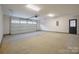 Spacious two car garage with lighting and black door to access exterior at 4890 Rio De Luna None, Hickory, NC 28601