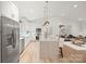 Open kitchen featuring white cabinets, stainless steel appliances, a large island, and modern pendant lights at 4890 Rio De Luna None, Hickory, NC 28601
