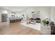 Bright, open-concept living room and kitchen with white cabinets and stainless steel appliances at 4890 Rio De Luna None, Hickory, NC 28601