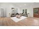 Cozy living room with hardwood floors, plush sofas, neutral color palette, and bright natural light at 4890 Rio De Luna None, Hickory, NC 28601