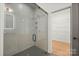 Bright shower with glass door and modern hardware, complemented by an adjacent walk-in closet for added convenience at 4890 Rio De Luna None, Hickory, NC 28601