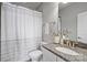 Stylish bathroom featuring a granite countertop, white cabinets, and a shower with gray and white curtain at 503 Dixter Ln, Charlotte, NC 28211