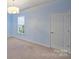 Bedroom with blue walls, carpeted floor, and window with blinds allowing for natural light at 503 Dixter Ln, Charlotte, NC 28211