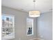 Bright bedroom featuring neutral walls, large windows, and modern drum light fixture at 503 Dixter Ln, Charlotte, NC 28211