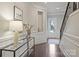 Elegant entryway featuring dark wood floors, paneled walls, staircase, and stylish console table at 503 Dixter Ln, Charlotte, NC 28211