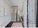Elegant entryway with dark wood floors, staircase, bench, and decorative rug with natural light at 503 Dixter Ln, Charlotte, NC 28211
