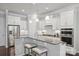 Modern kitchen with white cabinets, granite countertops, stainless steel appliances, and pendant lighting at 503 Dixter Ln, Charlotte, NC 28211