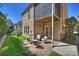Brick patio with seating area, lawn, and adjacent building with screened porch and brick facade at 503 Dixter Ln, Charlotte, NC 28211
