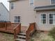 Exterior view of wood deck with steps leading down to backyard at 5032 Meadow Woods Dr, Lowell, NC 28098