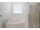 A bathroom featuring a soaking tub with shower and a glass enclosed shower at 5032 Meadow Woods Dr, Lowell, NC 28098