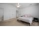 Bedroom featuring neutral tones, plush carpet, and ample closet space, creating a serene atmosphere at 5032 Meadow Woods Dr, Lowell, NC 28098