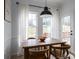 Charming breakfast area bathed in natural light, complete with a wooden table and picturesque outdoor views at 5032 Meadow Woods Dr, Lowell, NC 28098
