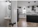 Bright kitchen with a view of a powder room, featuring a central island and modern stainless steel appliances at 5032 Meadow Woods Dr, Lowell, NC 28098