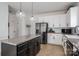Bright kitchen featuring granite countertops, a stainless steel refrigerator, and a functional kitchen island at 5032 Meadow Woods Dr, Lowell, NC 28098