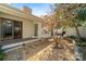 Beautifully landscaped backyard featuring a stone walkway and a partially covered patio area at 5101 Gamton Ct, Charlotte, NC 28226