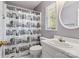 Bright bathroom featuring a shower with a unique black and white curtain and a round decorative mirror at 5101 Gamton Ct, Charlotte, NC 28226