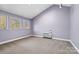 Spacious bedroom featuring three windows and high vaulted ceilings, freshly painted in a neutral tone at 5101 Gamton Ct, Charlotte, NC 28226