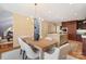 Open dining area with a modern chandelier and direct access to the kitchen with a large center island at 5101 Gamton Ct, Charlotte, NC 28226