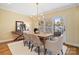 Bright dining room with a modern chandelier and a sliding glass door to the outdoor space at 5101 Gamton Ct, Charlotte, NC 28226
