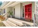 Inviting front porch featuring a bright red door, warm wood flooring, and a cozy welcome mat at 5101 Gamton Ct, Charlotte, NC 28226