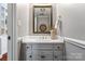 Cozy powder room featuring a neutral color palette, detailed mirror, and updated fixtures at 5101 Gamton Ct, Charlotte, NC 28226
