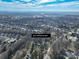 A high aerial view of a neighborhood reveals mature trees and single-Gathering homes at 624 Patricia Ave, Harrisburg, NC 28075