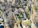 A bird's eye view shows a home with a fenced yard, patio, and verdant trees at 624 Patricia Ave, Harrisburg, NC 28075