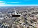 Aerial view showcases a neighborhood with tree cover and single-Gathering homes in a serene setting at 624 Patricia Ave, Harrisburg, NC 28075