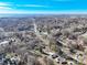 Aerial view showcases a neighborhood with tree cover and single-Gathering homes in a serene setting at 624 Patricia Ave, Harrisburg, NC 28075