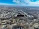 An aerial view shows a neighborhood with single-Gathering homes, trees, and blue sky at 624 Patricia Ave, Harrisburg, NC 28075