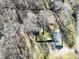 A bird's eye view shows a home with a fenced yard, patio, and verdant trees at 624 Patricia Ave, Harrisburg, NC 28075