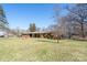 Well-maintained brick home with a large front yard and mature trees providing shade at 624 Patricia Ave, Harrisburg, NC 28075
