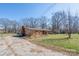 Ranch-style brick home with a long driveway and a spacious grassy front yard at 624 Patricia Ave, Harrisburg, NC 28075