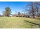 Spacious front yard with a brick home and a mature tree on a sunny day at 624 Patricia Ave, Harrisburg, NC 28075