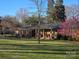 Charming brick ranch-style home with a sprawling lawn and a covered front porch, perfect for enjoying the outdoors at 624 Patricia Ave, Harrisburg, NC 28075
