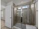 Bathroom with tiled shower, glass door, and decorative mosaic tile accent at 6846 Colonial Garden Dr, Huntersville, NC 28078