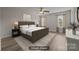 Staged primary bedroom features a neutral color palette, ceiling fan, and natural light at 6846 Colonial Garden Dr, Huntersville, NC 28078