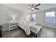 A bright bedroom featuring a bed, bench, and lots of natural light at 6846 Colonial Garden Dr, Huntersville, NC 28078