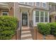 Inviting front entrance with a black screen door, concrete steps and black metal railings at 6846 Colonial Garden Dr, Huntersville, NC 28078