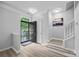 Open entryway featuring a black front door, fresh paint and wood-look flooring at 6846 Colonial Garden Dr, Huntersville, NC 28078