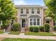 Charming townhome featuring a well-maintained lawn and neutral siding, enhanced by lush landscaping at 6846 Colonial Garden Dr, Huntersville, NC 28078