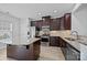 This kitchen features dark cabinets, stainless appliances, granite counters, and a central island at 6846 Colonial Garden Dr, Huntersville, NC 28078