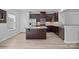 Open kitchen boasts stainless appliances, granite countertops, dark cabinets, and a spacious island at 6846 Colonial Garden Dr, Huntersville, NC 28078