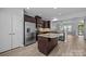 Open kitchen features granite counters, stainless appliances, dark cabinets, and access to the living area at 6846 Colonial Garden Dr, Huntersville, NC 28078