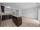 Open kitchen features a central island with granite counters and stainless steel appliances at 6846 Colonial Garden Dr, Huntersville, NC 28078
