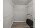 Spacious walk-in closet with wood-look flooring and wire shelving at 6846 Colonial Garden Dr, Huntersville, NC 28078