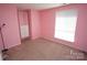 Bright bedroom featuring a built-in closet and a sunlit window, ready for personal touches at 7228 Rollingridge Dr, Charlotte, NC 28211