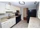 Kitchen features granite countertops, white cabinetry, and black appliances at 7228 Rollingridge Dr, Charlotte, NC 28211